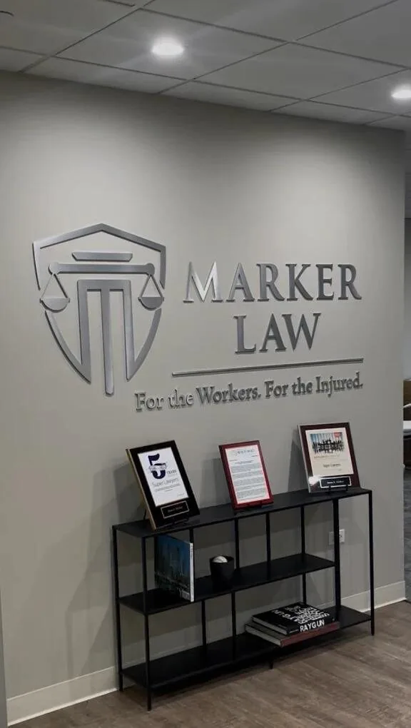 Marker Law office wall featuring the firm's logo and Super Lawyers / Best of Naperville awards